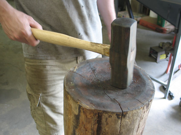 The striking face of the mallet is radiused to match the concave shape carved into the end of this old hardwood log.