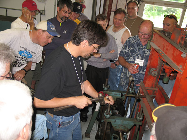 Hitting the high spot with a hammer and drift to straighten the crankshaft.