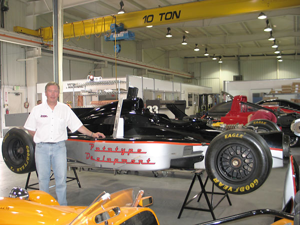 Mark Riley stands next to a Riley & Scott MkV Indy Car (circa 1997-99, about five were built).