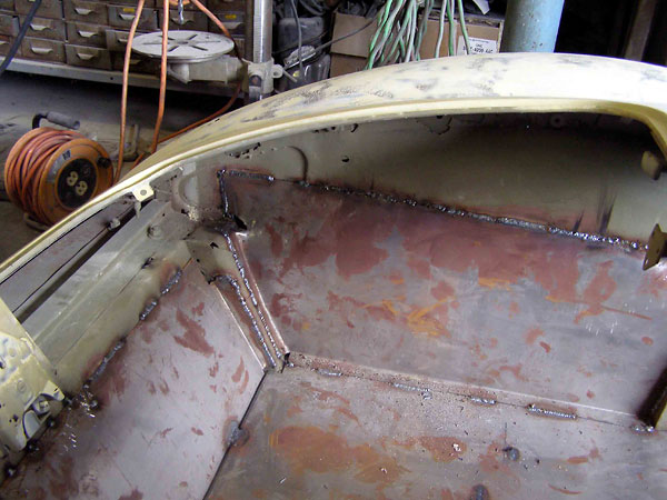 Paneling the luggage compartment with steel sheetmetal.