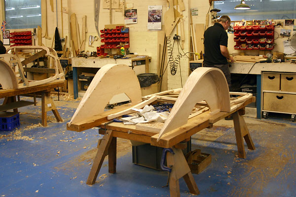 Rear fender arches are trimmed to width on a bandsaw.