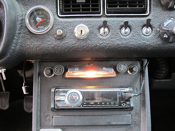Uncommonly subtle air conditioning controls. Note also the pop-out cupholder.