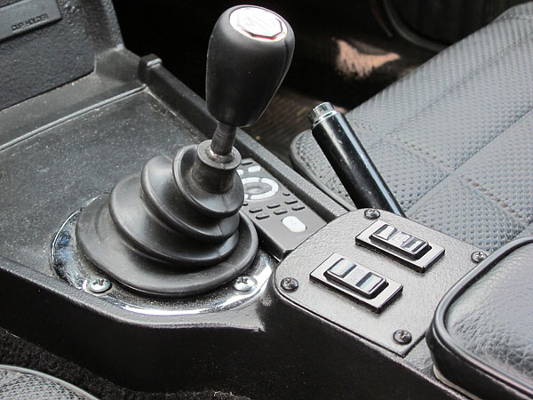 Gear shifter falls right where MG put theirs. Note power window switches.