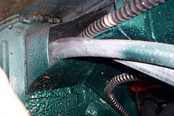 Heater hoses pass through the passenger's side wheel well.