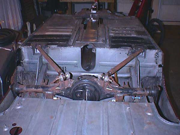 Custom 4-link MG Midget suspension with coil-over shocks.