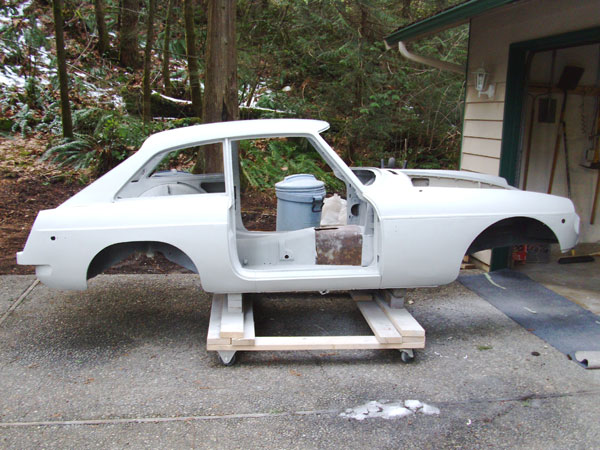 Primed bodyshell, ready for topcoats. A cart was constructed to move the bodyshell around in the garage.