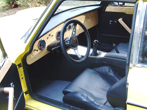Dash and console made from half inch birds-eye maple. Leather Recaro seats. Autometer gauges.