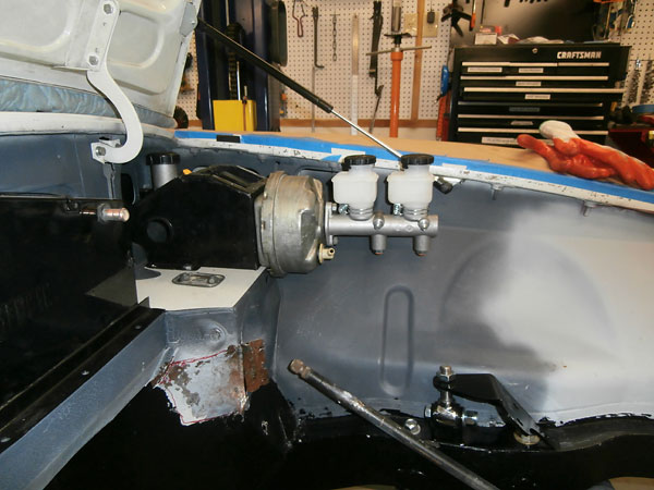 This brake master cylinder will fit, but only if its forward reservoir is mounted remotely.