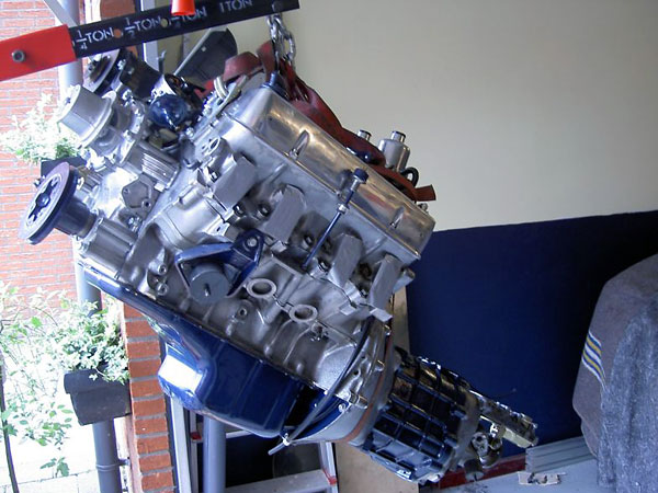 The engine on an engine hoist. Note the iron housing of the LT77 transmission.