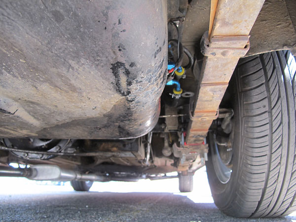 Stock MGB rear suspension, except for stiffer (red polyurethane) bushings and spring pads.