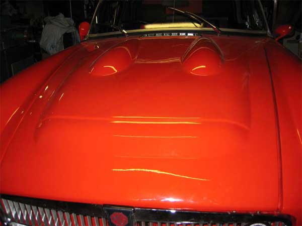 Two TR-5 hood bumps grafted onto a MGC hood to clear the carburetors and intake manifold