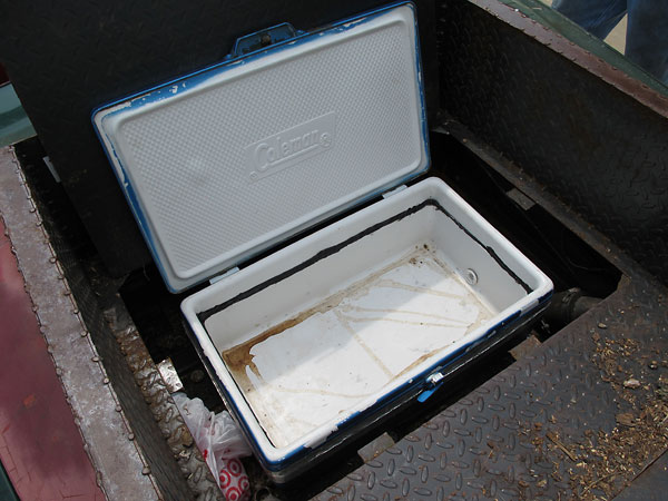 The pickup truck bed features a built-in drink cooler!