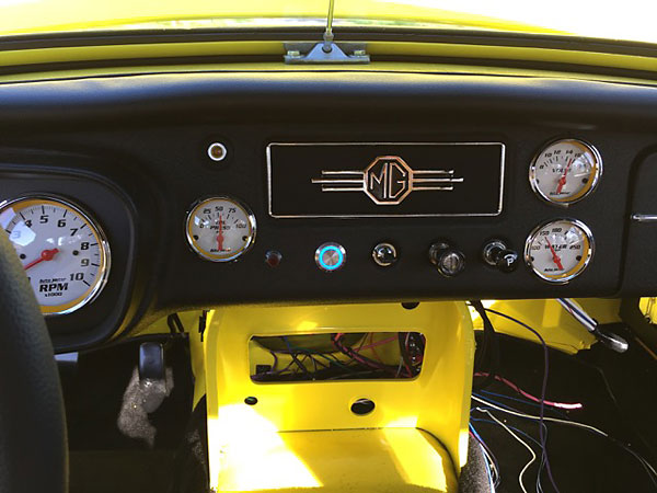 These gauges feature yellow rimmed white faces and blue illumination.