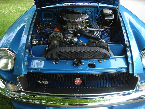 MGB GT V8 style (inverted, extended core) radiator and dual electric cooling fans.