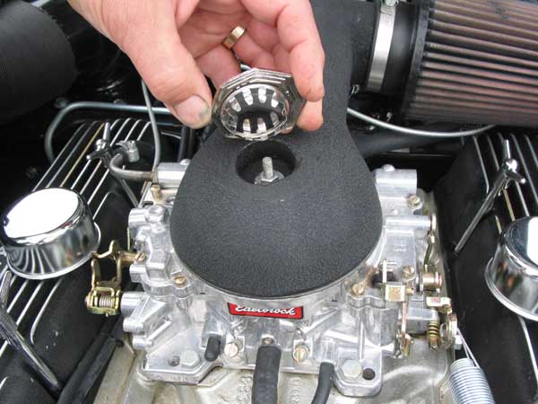 John shows how an MG badge hides the air cleaner removal nut.
