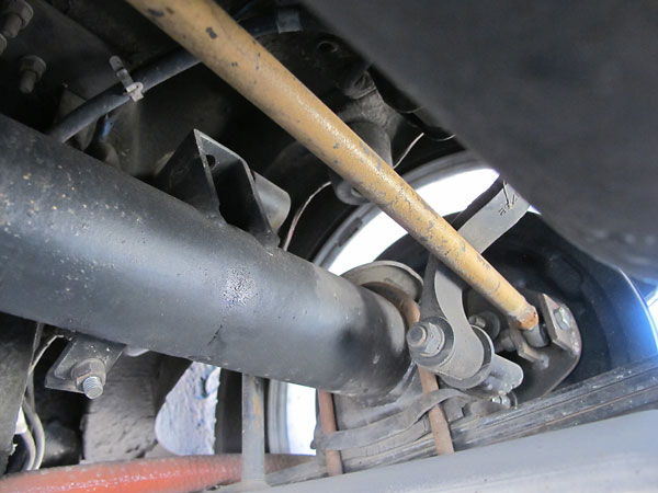 The Panhard rod mounts to the body at one end, and the axle at the other.