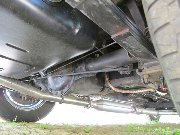 Dual header pipes converge into single 2.5 inch stainless steel exhaust pipe. Hushpower muffler.