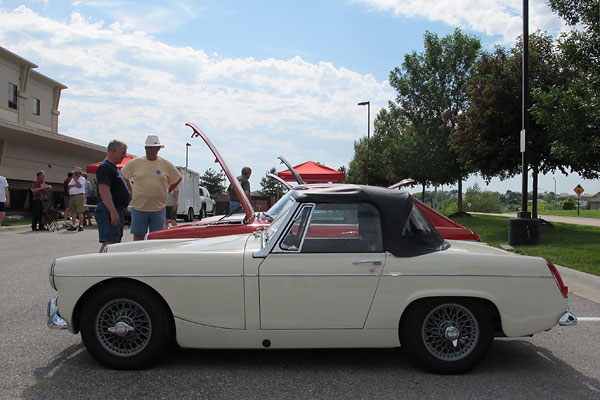 Rather than folding rearward and stowing flat, the top comes off and stows in the trunk.