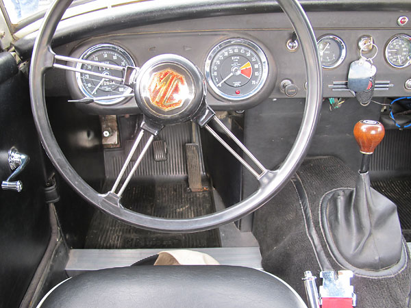 Stock MG Midget steering wheel and gauges.