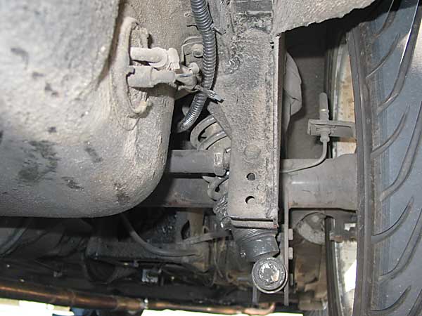 Panhard rod mounted rearward of the coil-over shocks