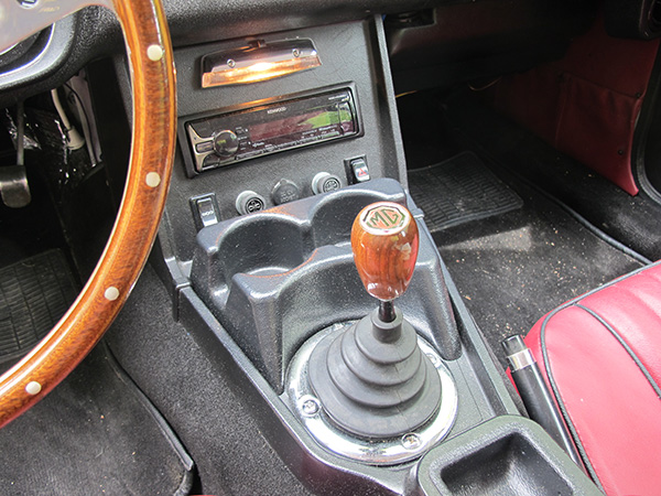 Aftermarket console-mounted two-bay cupholder.