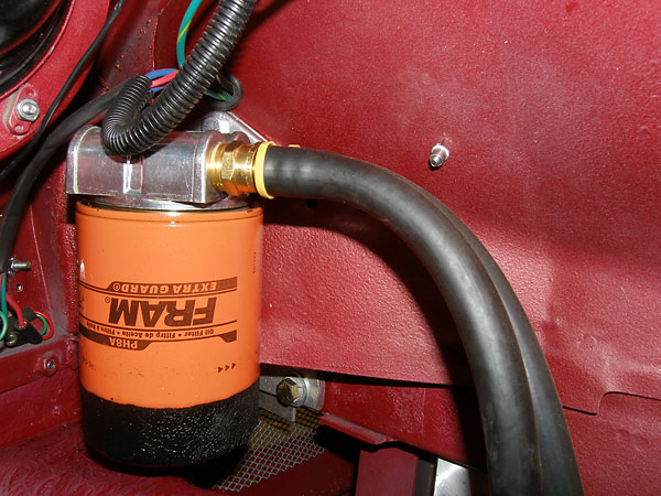 Fram PH8A oil filter, mounted under driver-side fender.