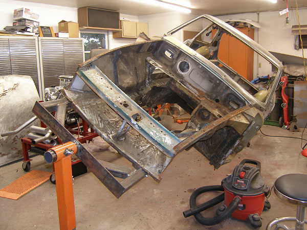 Stripped down to a just its unibody bodyshell, and mounted on a rotisserie for better access.