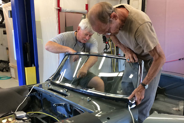 It took two men and a boy to install the MGB windshield.