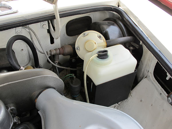 Power brake booster and windshield washer fluid bottle.