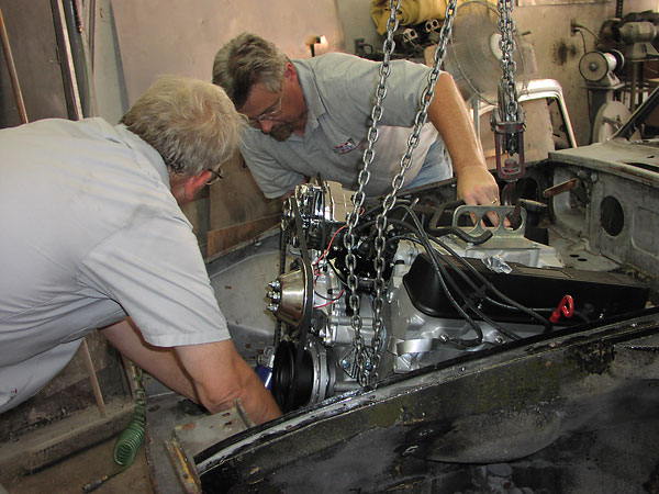 Careful trial installation of the Rover V8 engine.