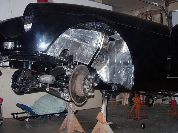 Stock MGB front suspension with heavier springs and lowered steering rack (for engine clearance).