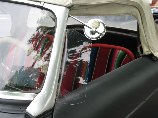 Chrome bicycle mirror and custom acrylic air deflectors.)