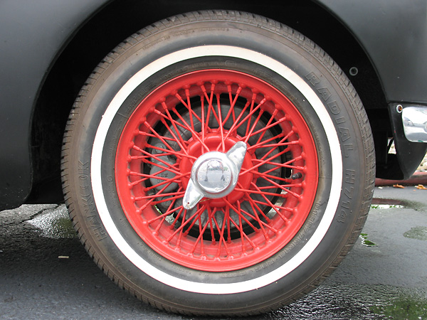 Stock MGB wire wheels, painted red. Hankook H714 radial tires (185/75-R14).
