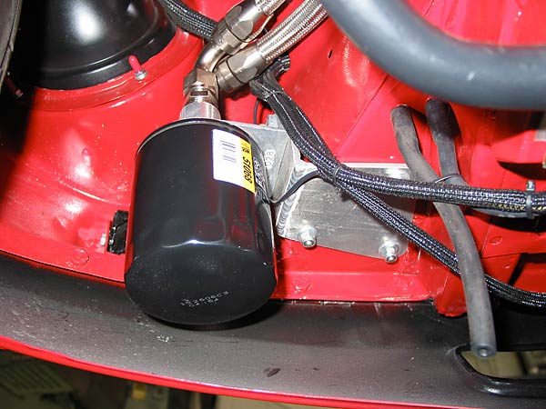 The oil filter is mounted below the driver-side headlamp bucket.