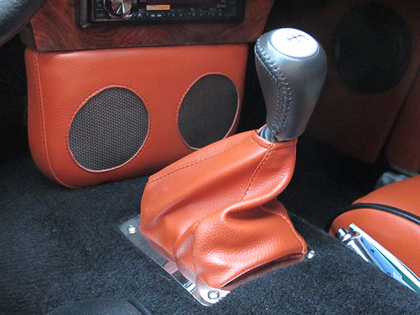 Custom fabricated and upholstered speaker console and shifter boot.