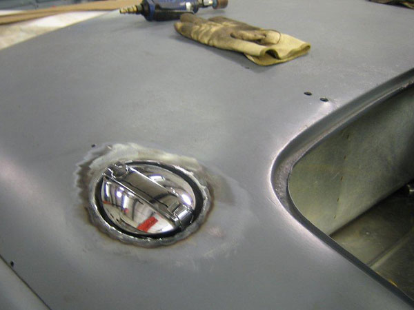 Sunbeam Tiger semi-recessed hinged fuel filler cap, located higher on the fender than stock.