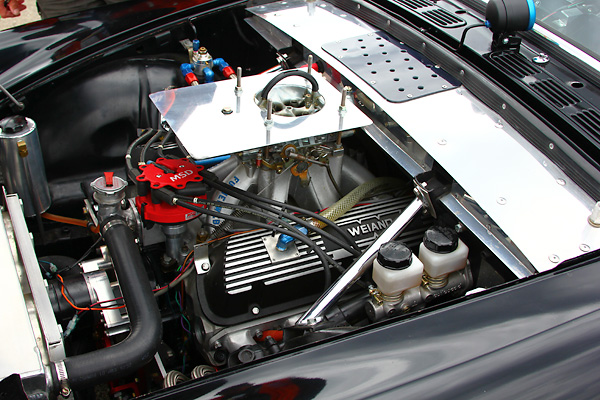 Parker funnel-web intake manifold and Barry Grant carburetor.