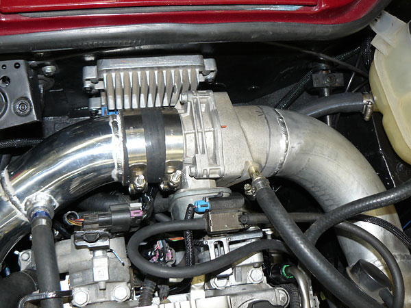 Drive-by-wire throttle body. Engine Control Module mounted on firewall.