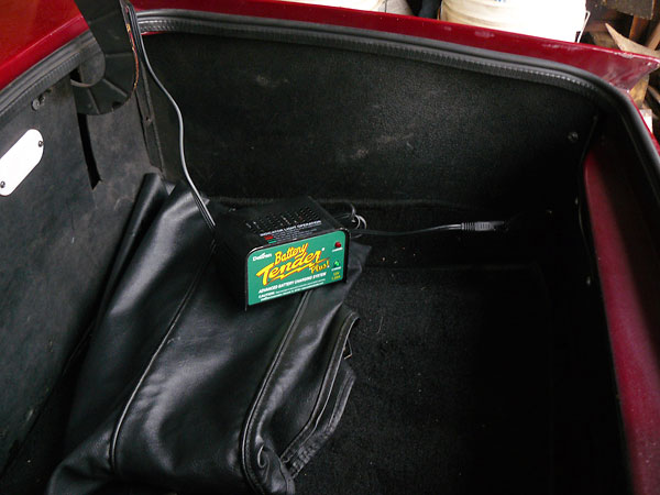 The battery is neatly hidden when the trunk carpet is in place.