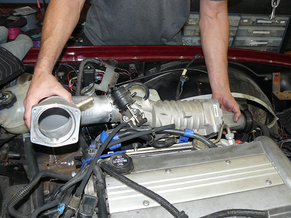 Throttle body mounting flange re-installed with 90-degree elbow.