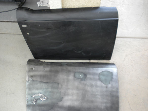 A replacement door skin, pre-primed black, is shown here ready to install.