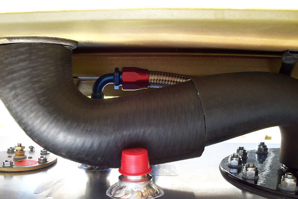 A stock Triumph TR6 fuel filler connects to a two inch inside diameter hose.