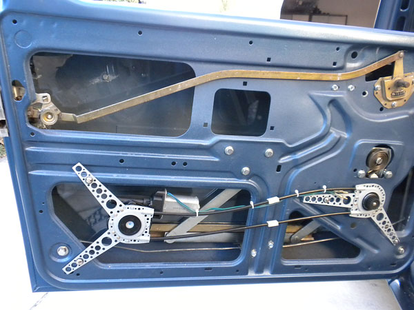 Mounting the SPAL power window kit in a Triumph TR6 door.