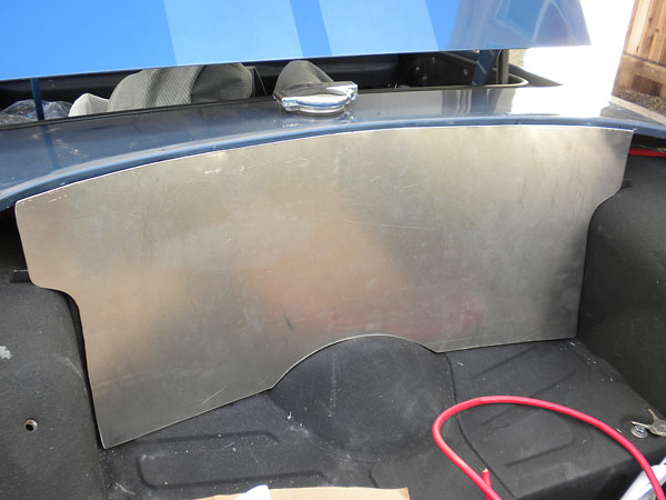 Thin aluminum firewall between fuel tank and passenger compartment.