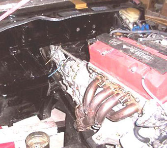 The two collector tubes off the Honda headers were cut off short to later be modified to fit.