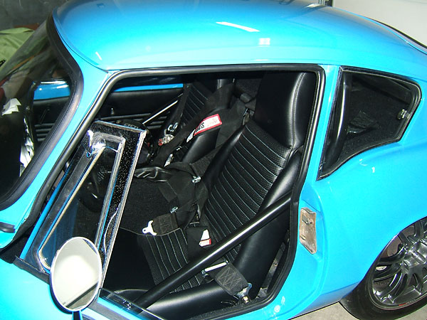 Original Triumph seats, reupholstered with light blue accent stitching.