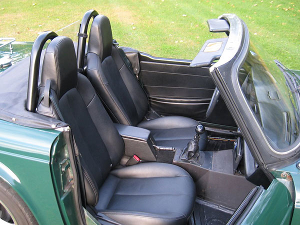 Mazda Miata seats. Custom double roll hoop, with wind blocker.