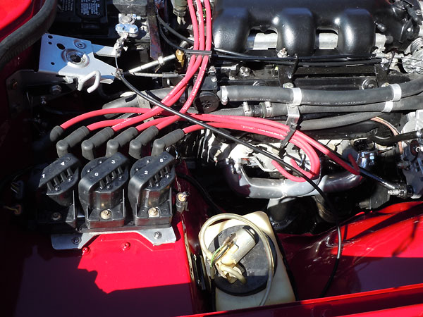 Three dual-tower coil packs sit atop a GM (AC Delco) Ignition Control Module.