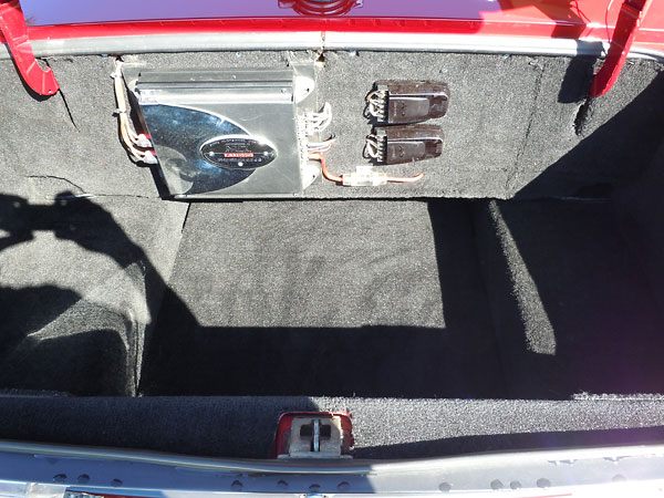 Spare tire removed & trunk area carpeted over. MTX Thunder 4244 audio amplifier.