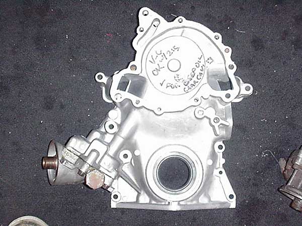 Later Buick V6 cover. No timing mark tab. Note Metric oil pump cover pointing horizontally. 